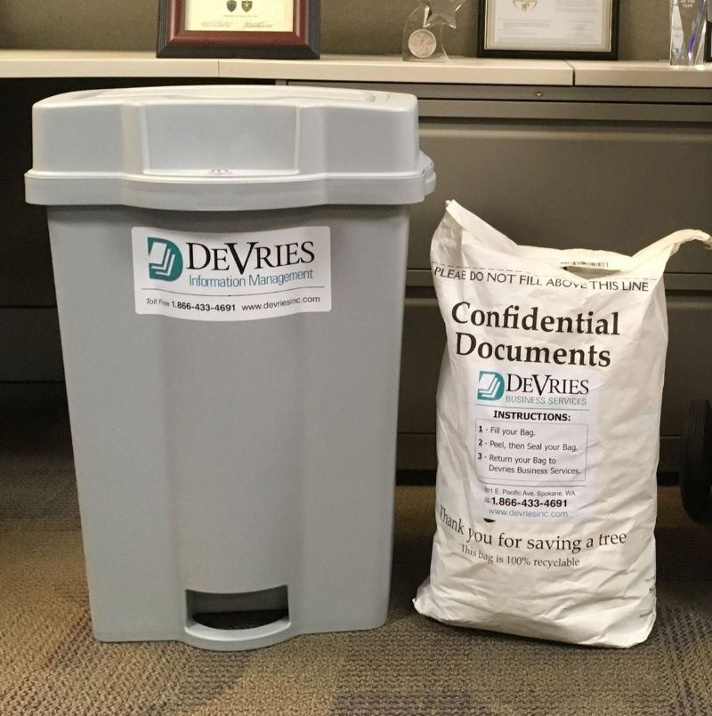 Two DeVries branded collection containers, one bag and one plastic console