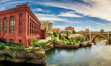Wide-angle view of Washington Water Power building and the Monroe Street Bridge along the Spokane river, in Spokane, Washington.