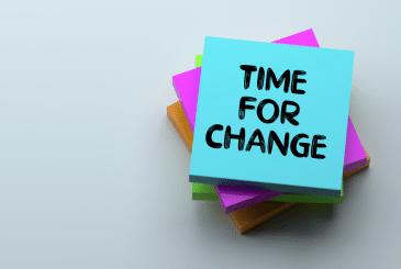 A stack of sticky notes. The top note reads "Time for Change"