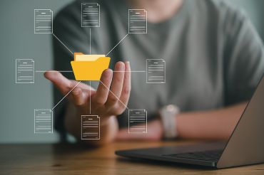 Business person cupping hand under virtual folder and document icon 