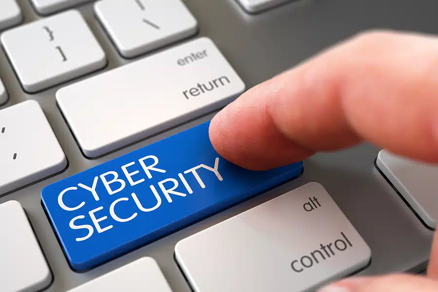A finger pressing Cyber Security Key on a keyboard.