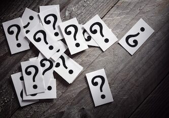 Question mark heap on table concept for confusion, question or solution