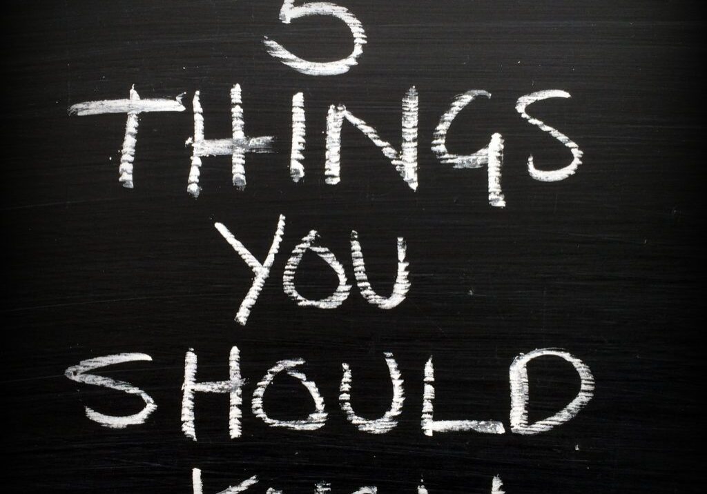The phrase Five Things You Should Know written in white chalk on a blackboard as a reminder to prepare and set priorities