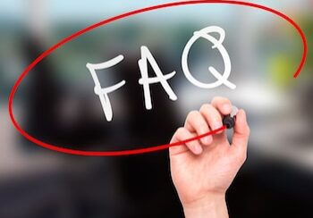 Man Hand writing FAQ - Frequently Asked Questions with marker on transparent wipe board. Business, internet, technology concept.