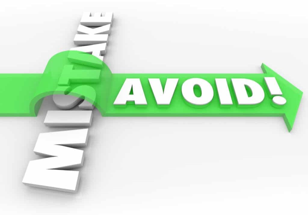 Avoid Mistake words in 3d letters and a green arrow over the word to illustrate preventing a problem, error, difficulty or inaccuracy