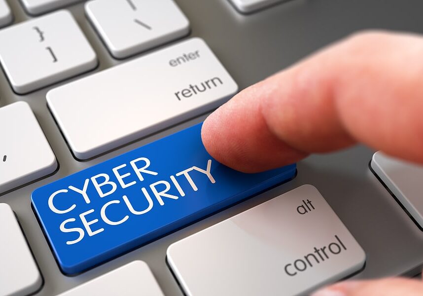 A finger pressing Cyber Security Key on a keyboard.