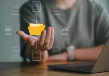 Business person cupping hand under virtual folder and document icon